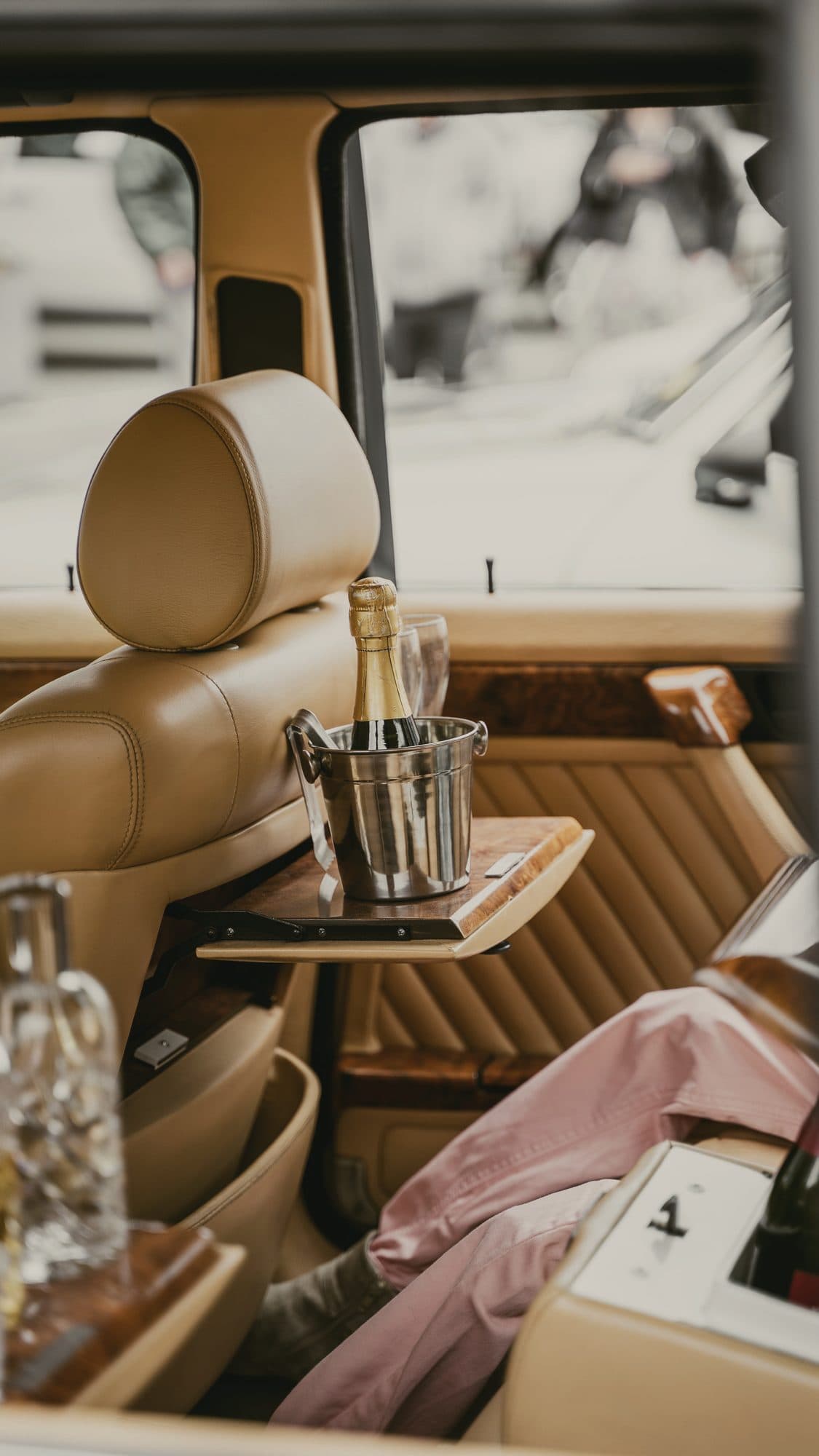Champagne on ice in the back of a classic car